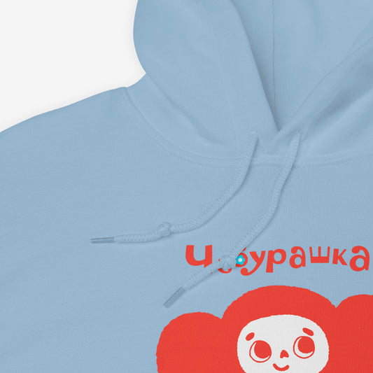 Light blue unisex hoodie featuring minimalist red Cheburashka with a birthday cake. Cute red-pinkish color. With Чебурашка logo on the necktag label. Closeup print photo. www.cheburashkashop.com