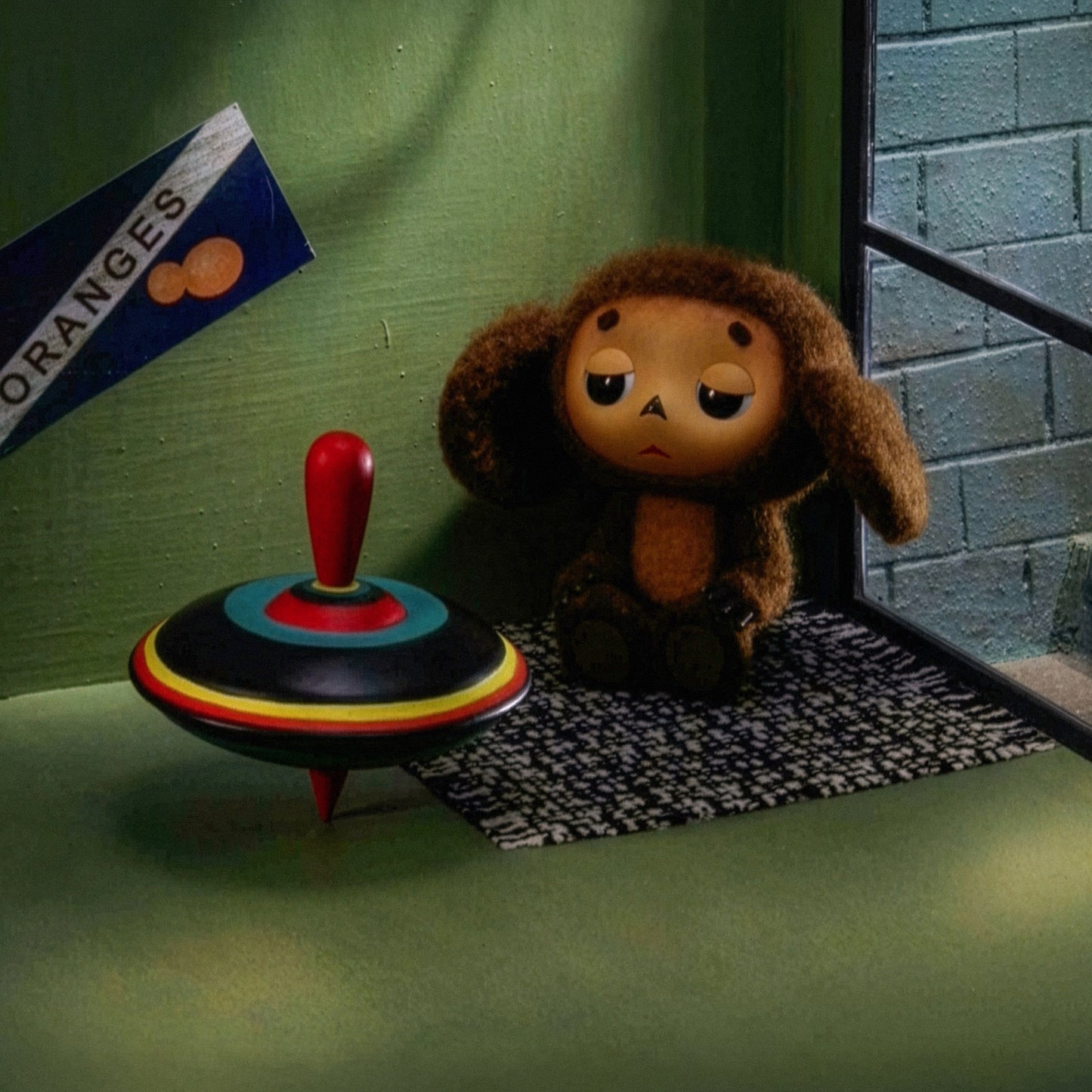 Large 91x61cm poster of original Soviet cartoon character Cheburashka sitting sad in phone booth. 2013 edition. Closeup.