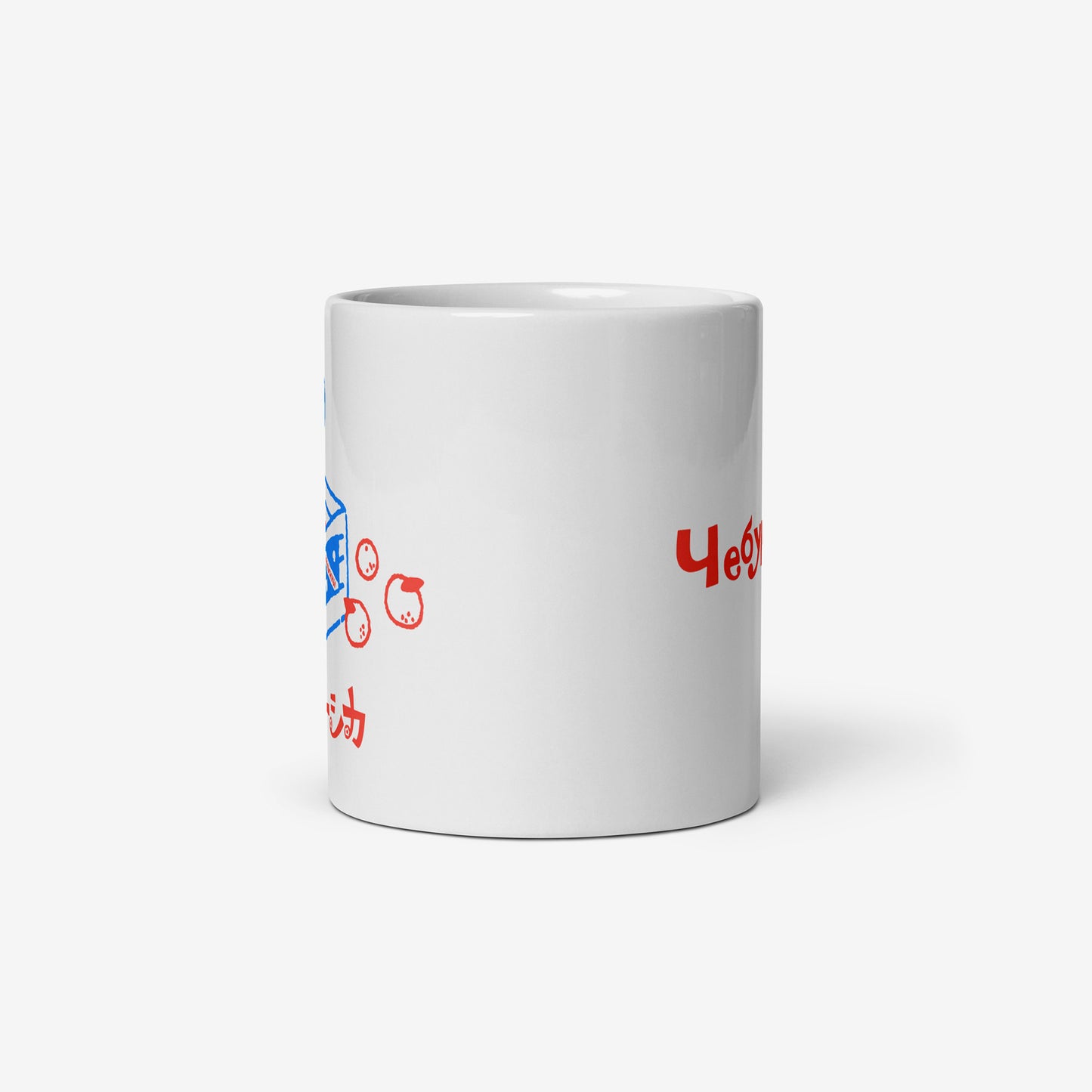White coffee cup with Cheburashka sitting on a box of oranges and チェブラーシカ logo in red. Side.