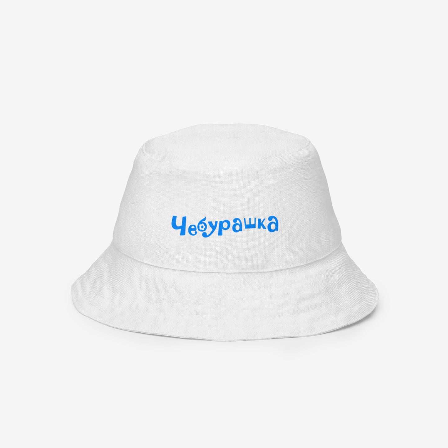 A white reversable bucket hat with a Soviet cartoon character Cheburashka pattern in red and blue. Front side 2a.