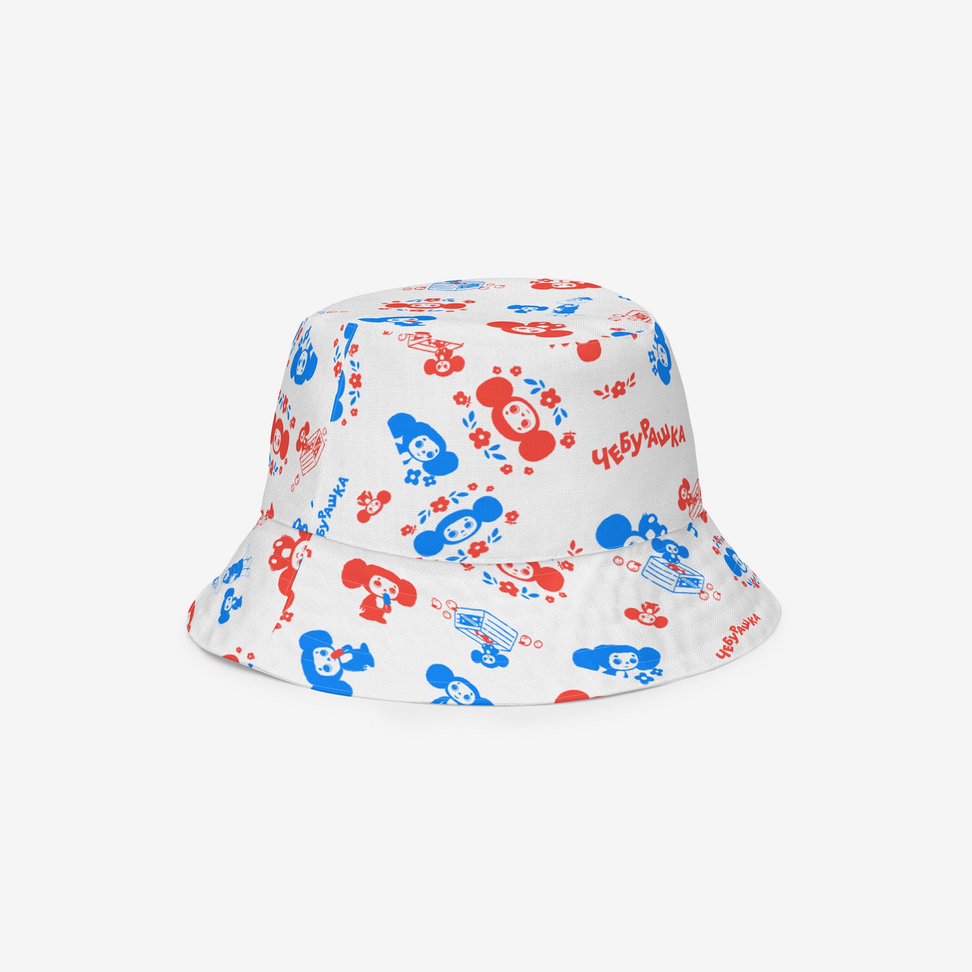 A white reversable bucket hat with a Soviet cartoon character Cheburashka pattern in red and blue. Front side 1b.
