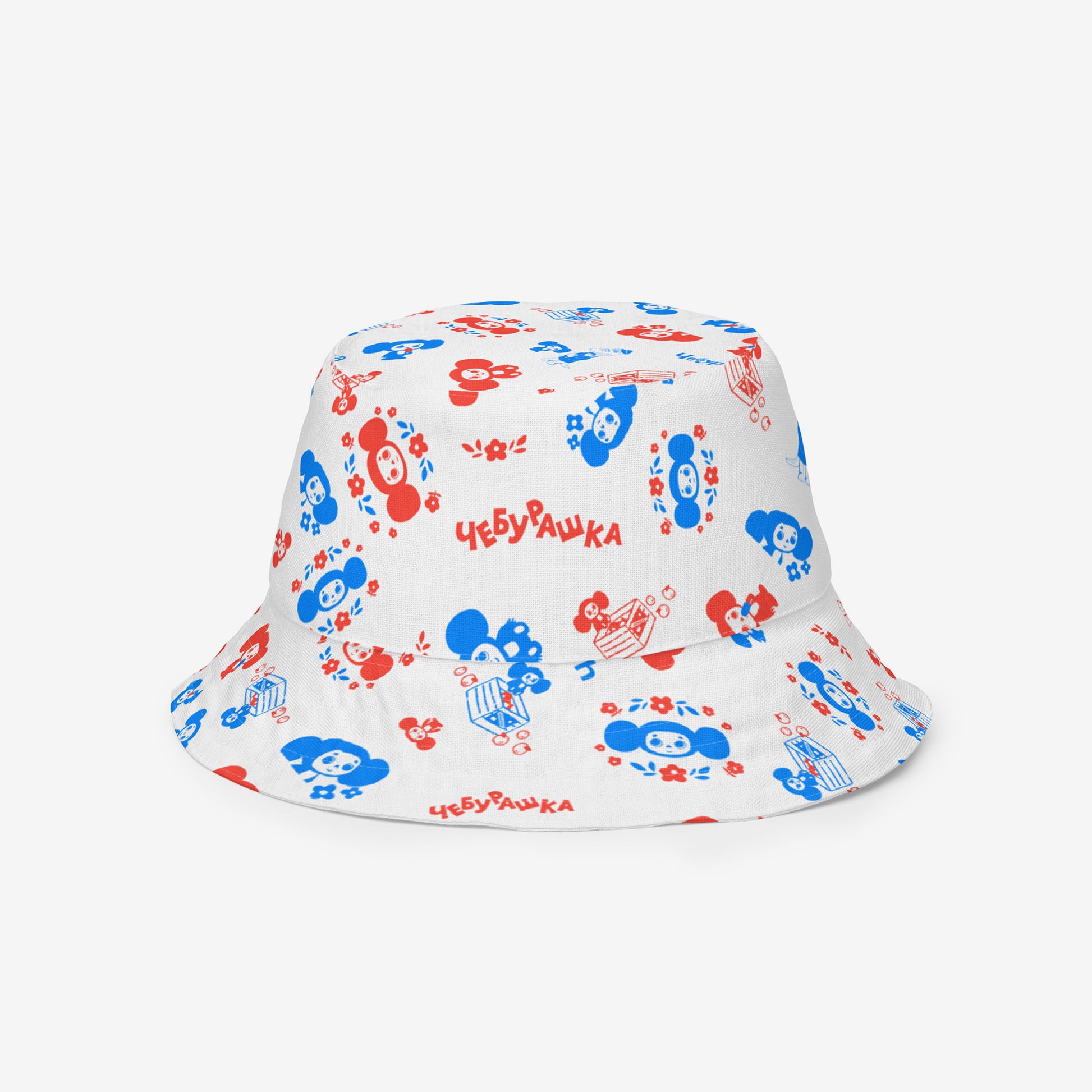 A white reversable bucket hat with a Soviet cartoon character Cheburashka pattern in red and blue. Front side 1.
