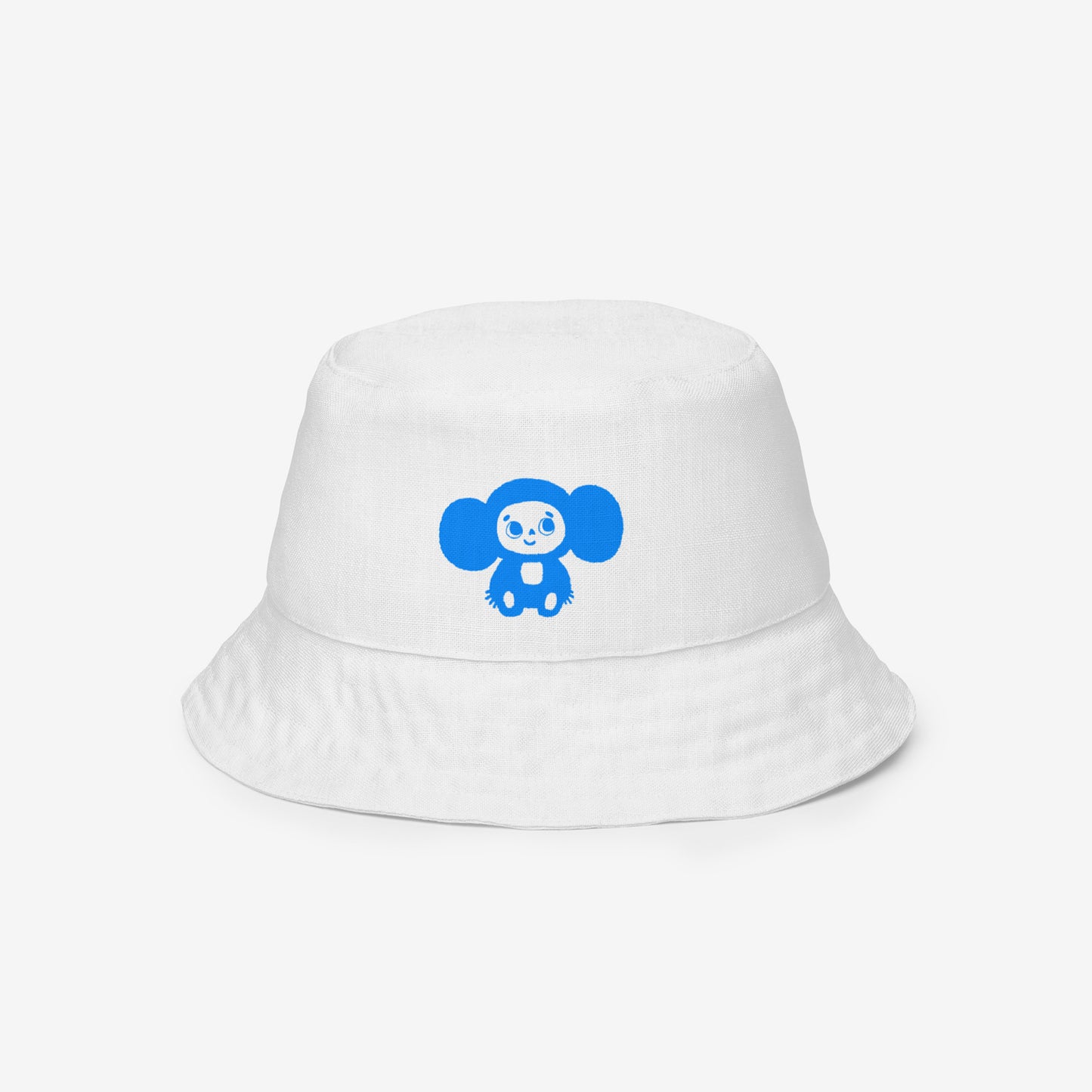 A white reversable bucket hat with a Soviet cartoon character Cheburashka pattern in red and blue. Front side 2b.
