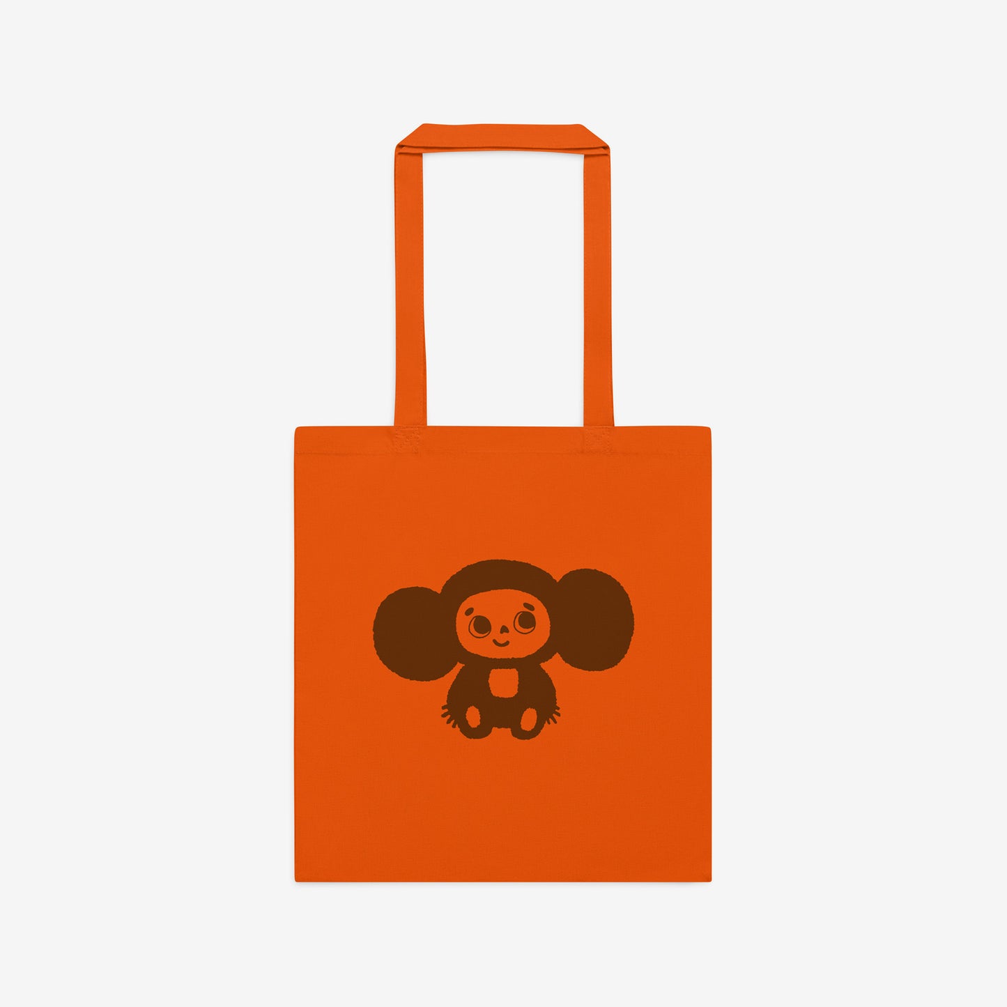 Orange tote bag with original Soviet cartoon character smiley minimalist Cheburashka on one side and Чебурашка logo on the other side. Front.