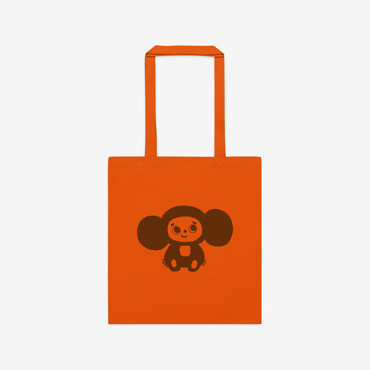 Orange tote bag with original Soviet cartoon character smiley minimalist Cheburashka on one side and Чебурашка logo on the other side. Front.