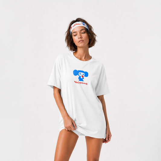 A cute fit model girl wearing white athletic headband featuring a colorful Soviet cartoon character Cheburashka pattern in blue and red, with the brand name 'Чебурашка' printed in black on the inside. Front side.