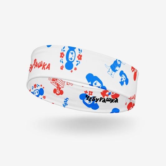 A white athletic headband featuring a colorful Soviet cartoon character Cheburashka pattern in blue and red, with the brand name 'Чебурашка' printed in black on the inside. Front side.