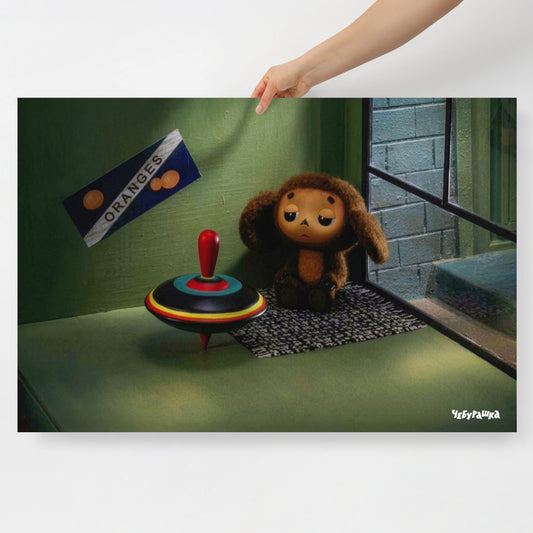 A hand holding large 91x61cm poster of original Soviet cartoon character Cheburashka sitting sad in phone booth. 2013 edition. 