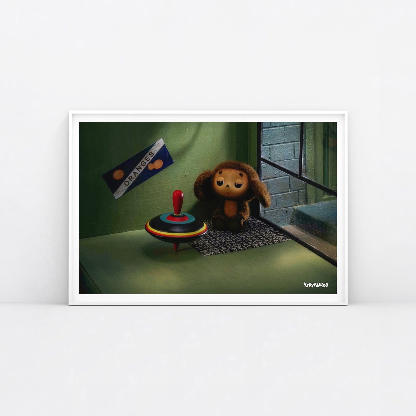 Large 91x61cm poster of original Soviet cartoon character Cheburashka sitting sad in phone booth. 2013 edition. Framed.