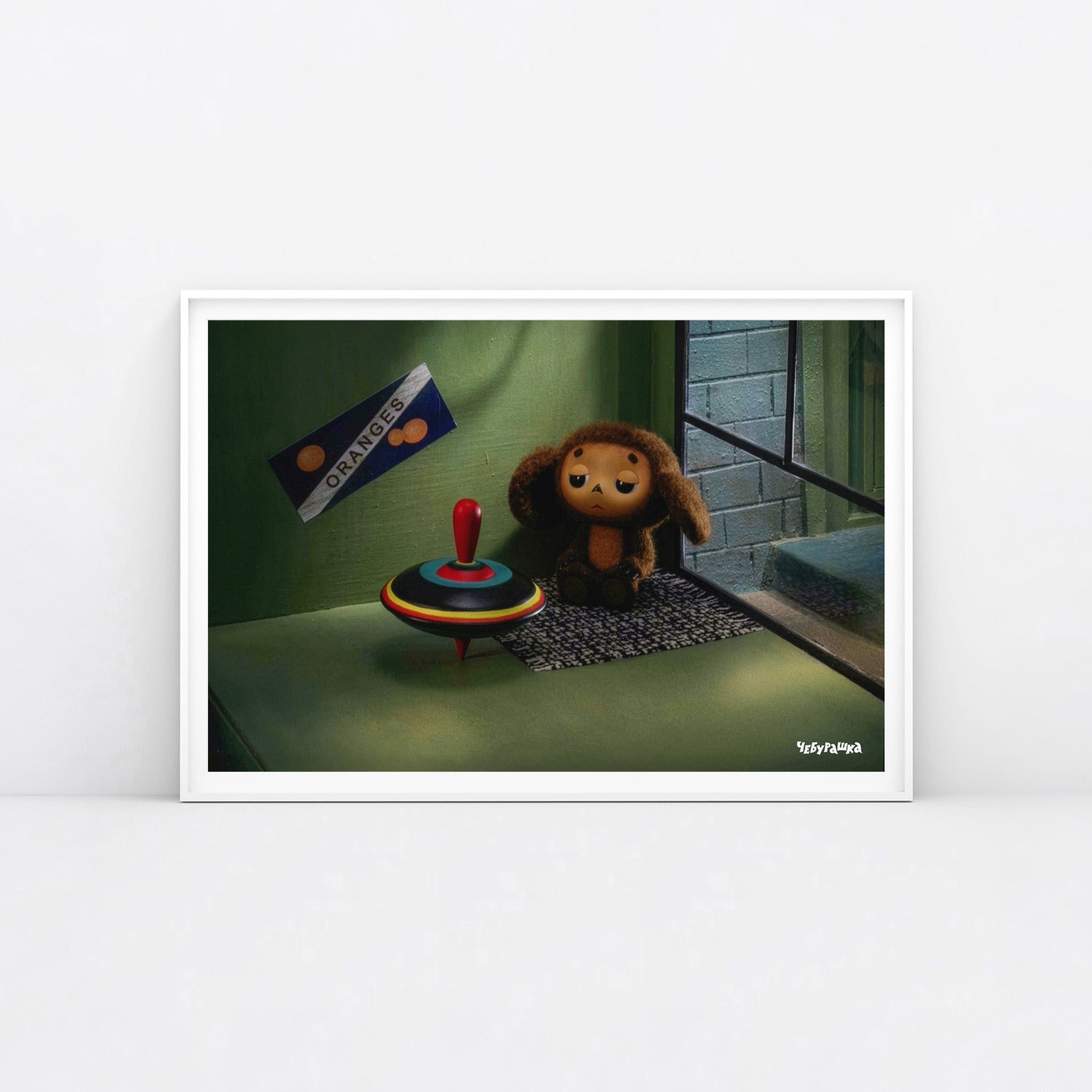 Large 91x61cm poster of original Soviet cartoon character Cheburashka sitting sad in phone booth. 2013 edition. Framed.