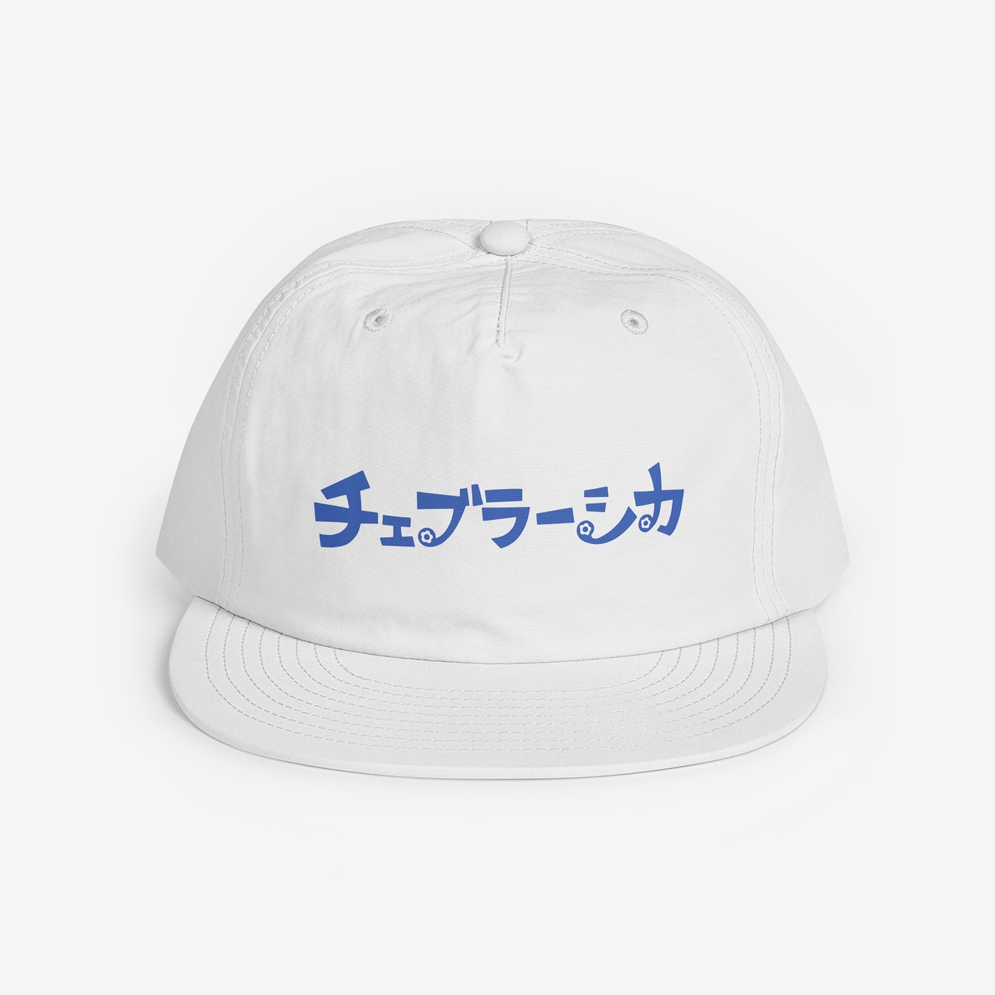 A white surf cap with a flat brim, featuring Cheburashka Soviet cartoon logo in japanese チェブラーシカ on the front. Front side.