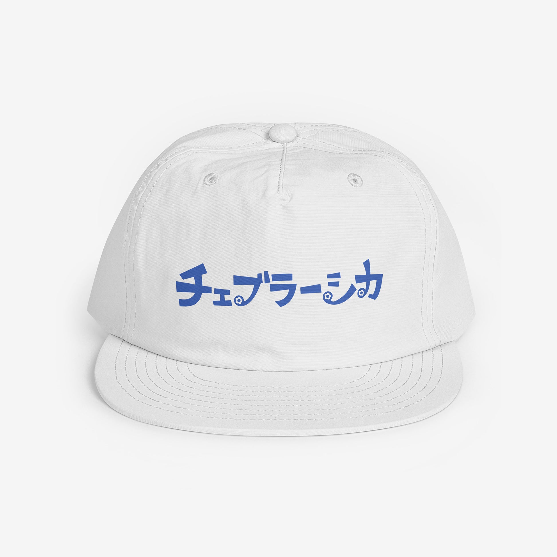 A white surf cap with a flat brim, featuring Cheburashka Soviet cartoon logo in japanese チェブラーシカ on the front. Front side.