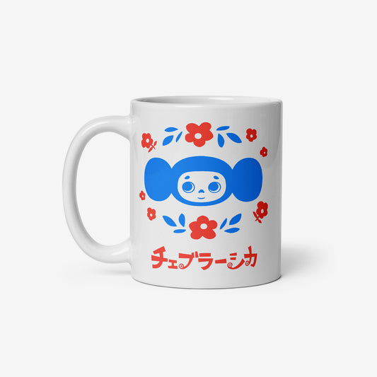 White coffee cup with Cheburashka among a pattern of flowers and チェブラーシカ logo. Front.