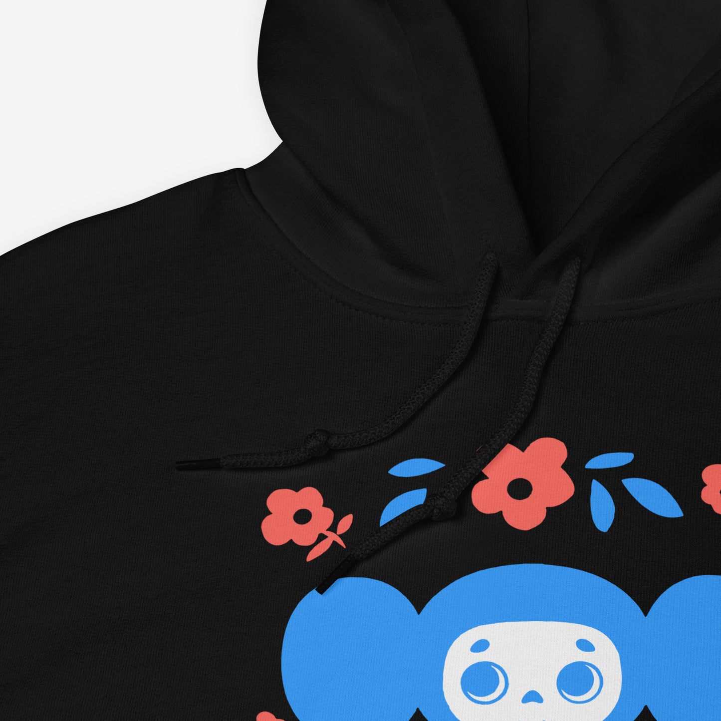 Black unisex hoodie with original Soviet cartoon character Cheburashka among a pattern of flowers and with logo in japanese チェブラーシカ. Closeup print details.