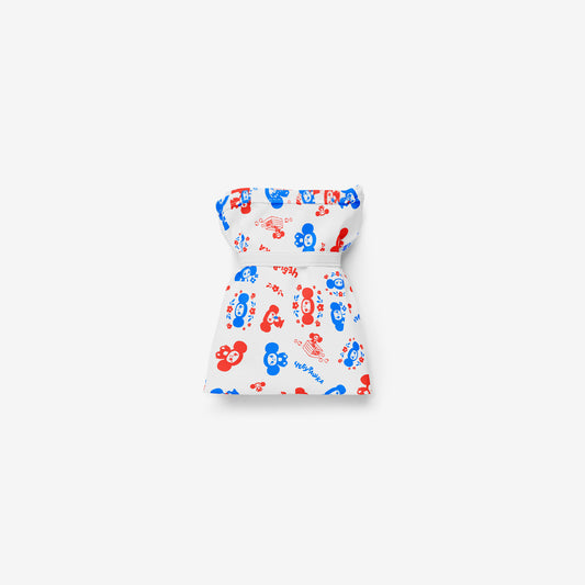A reusable folding shopping bag with a white background and an all-over pattern of red and blue Soviet cartoon character Cheburashka. Folded.