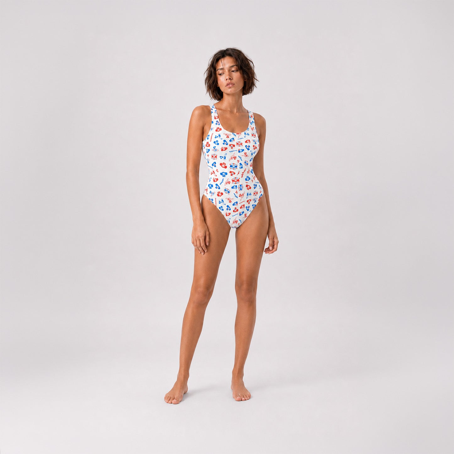 Sexy fit young model girl wearing Cheburashka pattern one-piece swimsuit.