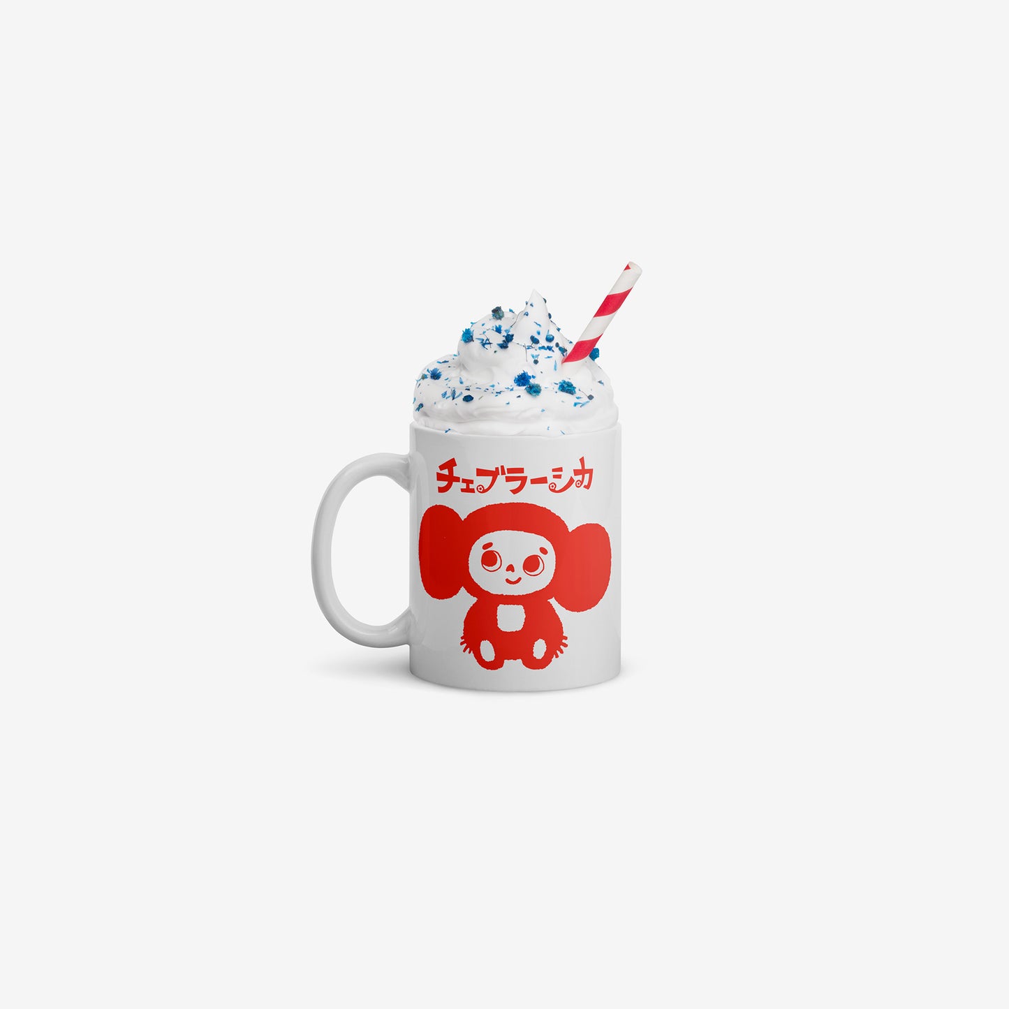 White coffee cup with minimalist graphic of smiley Cheburashka and チェブラーシカ logo in red. Filled with whipped cream drink and a stripped drinking straw.