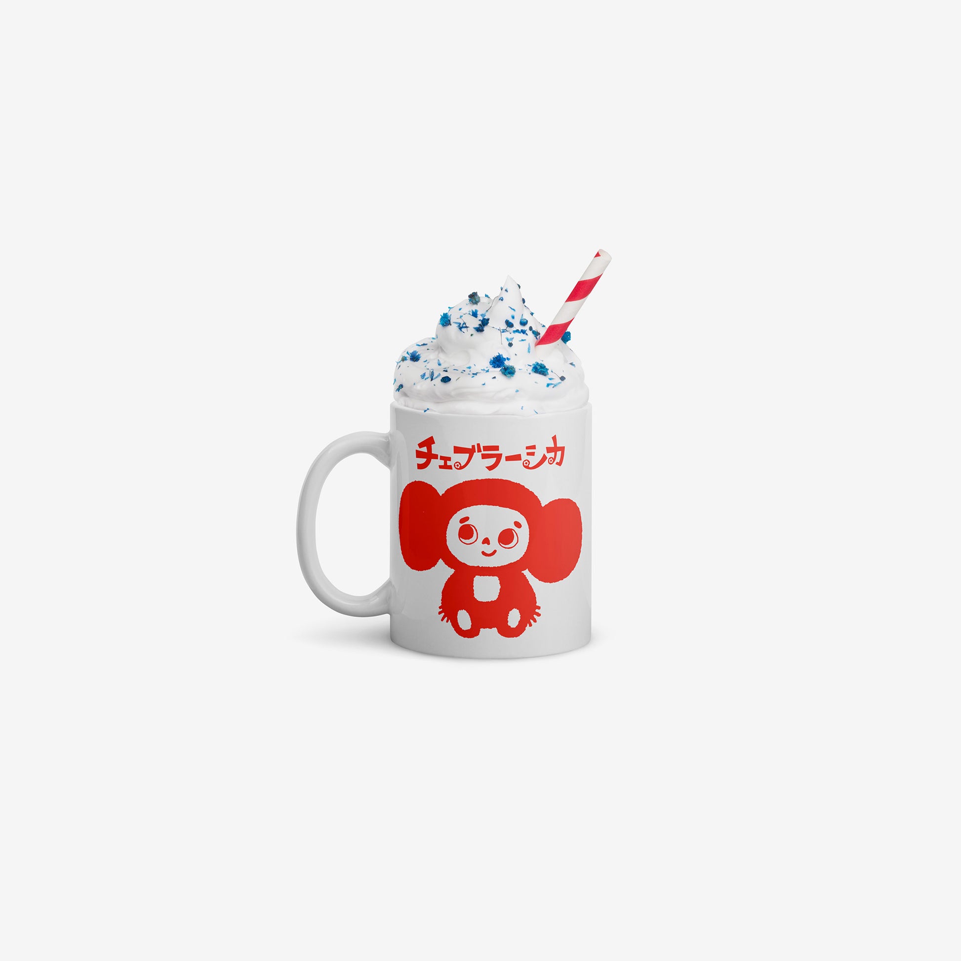 White coffee cup with minimalist graphic of smiley Cheburashka and チェブラーシカ logo in red. Filled with whipped cream drink and a stripped drinking straw.